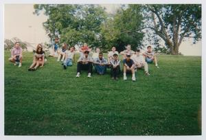 [Photograph of TAMS students posing on grass field]