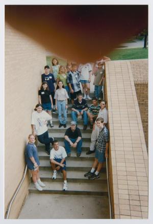 [Photograph of TAMS group posing on outdoor stairs]