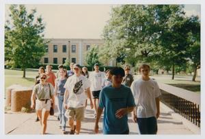 [Photograph of TAMS group walking on campus]