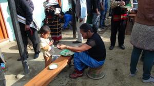 Photograph of a lady having  meal during the first death anniversary of late Behon Shilshi Deeringkhu Chandel