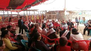 Primary view of object titled 'Photograph of crowd and singers during the first death anniversary of late Behon Shilshi at Deeringkhu village'.