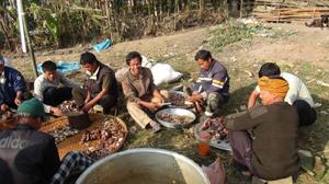 Lamkang community meat cutting by men during the first death anniversary of late Behon Shilshi at Deering Khu village.
