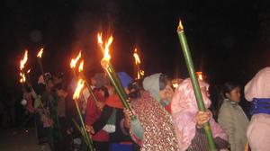 Photograph of women carrying torch during protest vigil at night in Chandel Manipur