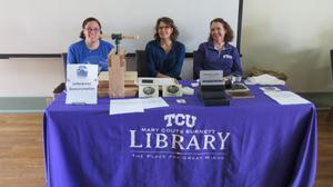 [Workers at TCU Library table]