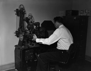 Primary view of object titled '[Employee using film equipment]'.