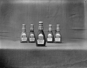 Primary view of object titled '[Bottles of White Swan dressings]'.