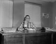 Primary view of [Calvin Pigg at his desk]