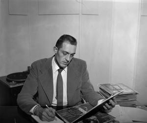[Photo of a man working at a desk]