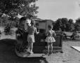 Photograph: [Children standing in back of truck]