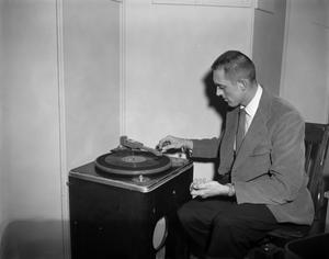 [Man working on a record player]