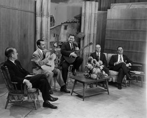Primary view of object titled '[Men on sitting in chairs on set]'.