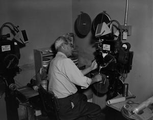 [Man with a film equipment]
