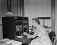 Photograph: [Judy operating a telephone switchboard]