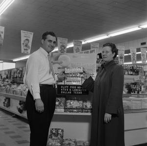 [Man and woman stand in front of store display at Cliff Food 2 of 2]