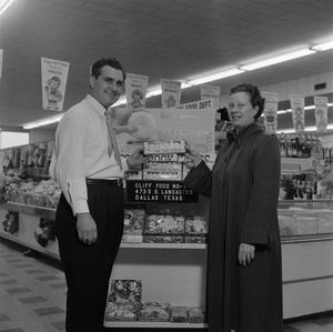 [Man and woman stand in front of store display at Cliff Food 1 of 2]