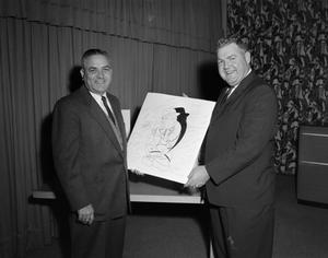[Roy Bacus holding a drawing with Doc Rhuman]