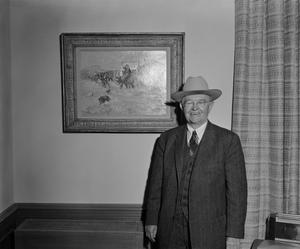 [Howard Hugh in front of painting]