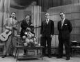 Thumbnail image of item number 1 in: '[Photo of four men standing on set]'.