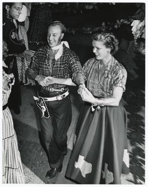 [Photograph of Jacques Fath with Billie Marcus at a Western party]