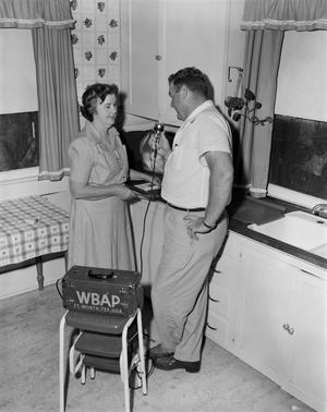 [Doc Rhuman interviewing a woman in a kitchen]