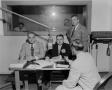 Photograph: [Photograph of men in studio signing contract]