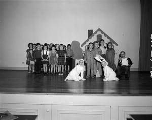 [Photo of students on stage at S.S. Dillo School]