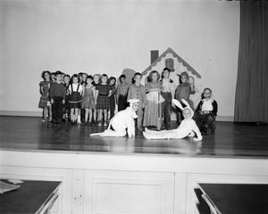 [Photo of school children on stage at S.S. Dillo School]