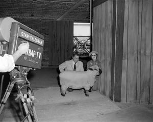 [Doc Rhuman and a guest with a sheep]