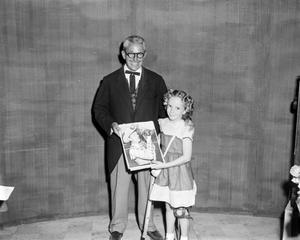 [Bobby Peters with contest winner holding portrait]