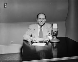 [Photograph of Bud Sherman seated at table]