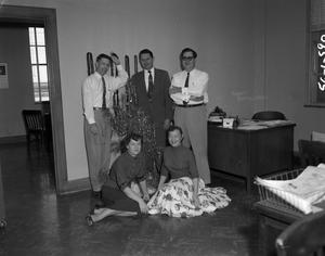 [Robert Gould with group next to Christmas tree]