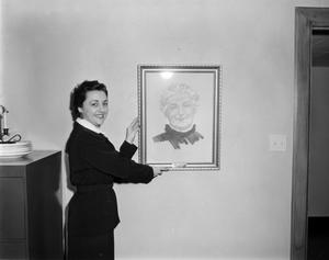 [Margaret McDonald holding a portrait drawing of Mrs. Tucker]