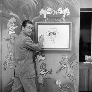 [Photograph of Johnny Hay drawing on set]