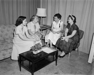 [Ann Alden speaking with a group of women]