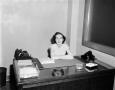 Photograph: [Photo of woman at desk]