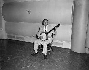 [Photograph of man playing a banjo]