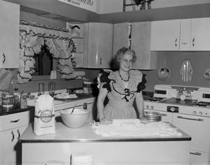 [Photograph of woman baking]