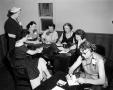 Thumbnail image of item number 1 in: '[Photograph of a group of women at a table]'.