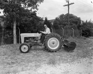 [Doc Rhuman on a Ford tractor]