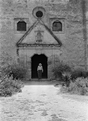 [Photograph of a man in the doorway of Mission Concepción in San Antonio]