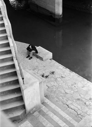 [Photograph of a man on the riverwalk]