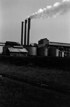 [A factory with smokestacks]