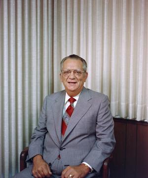 [Photograph of a man in a suit and a red tie, 4]