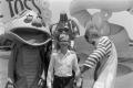 Photograph: [A boy posing with carnival characters]
