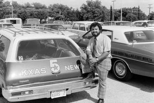 [Bernie Tamayo next to a WBAP news vehicle at KXAS]