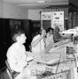 Photograph: [Photograph of four employees working in radio studio]