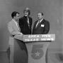 Photograph: [Men standing behind a podium]