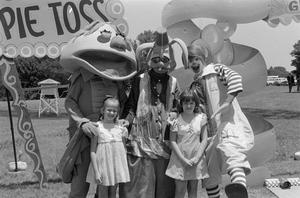 [Children with costumed characters]