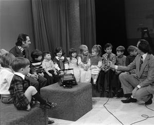 [Photograph of Bill Kelley interviewing a boy at a KXAS Christmas Children's Hour party]