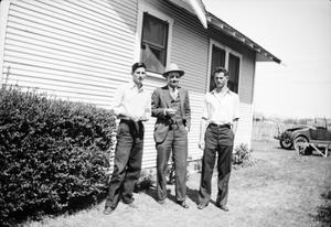 [Photograph of John Williams, an unknown man, and Byrd Williams III outdoors]